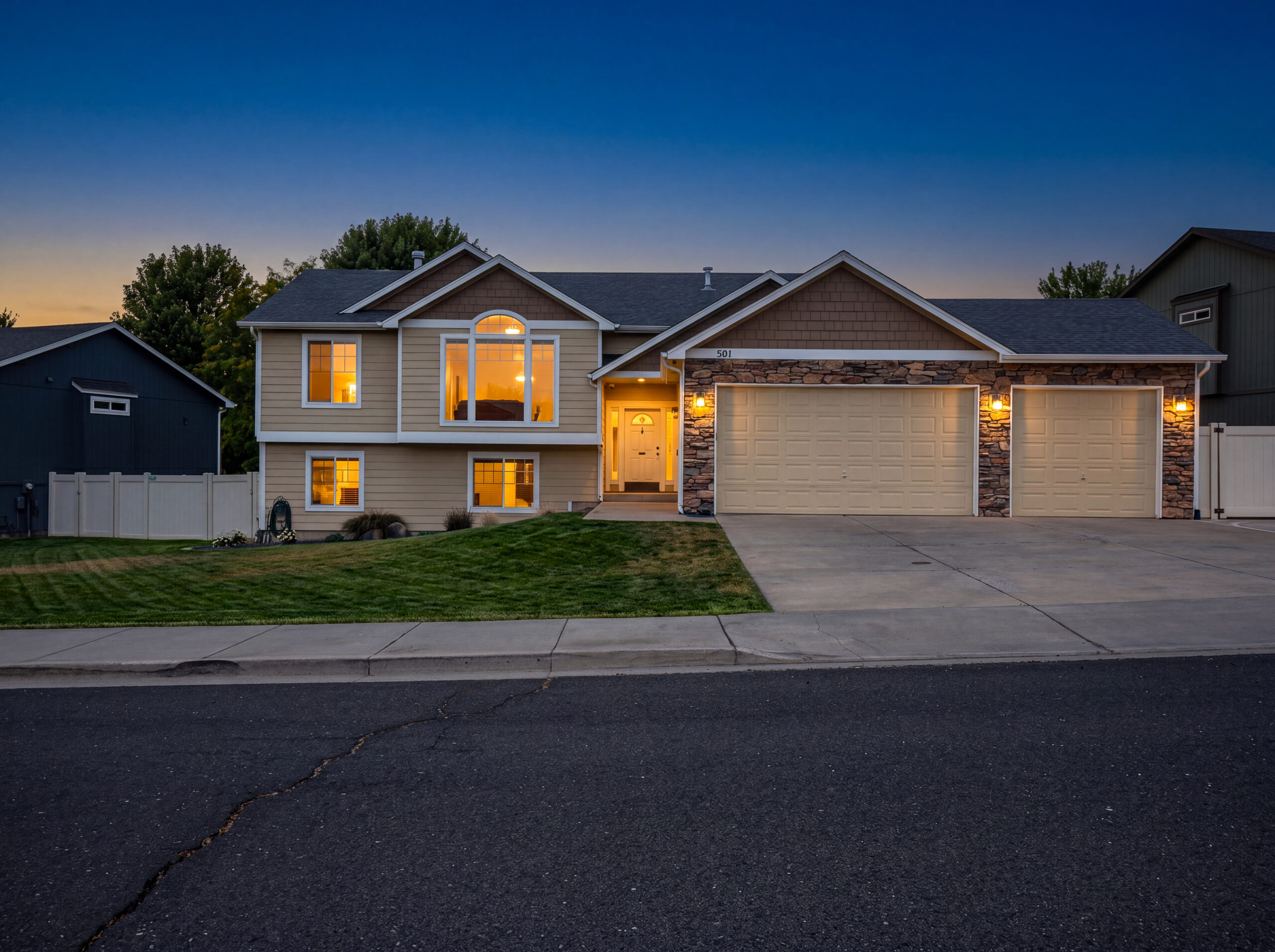 501 E Parker Dr at twilight, windows glowing against a dusk sky